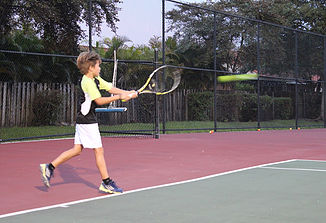 child playing tennis