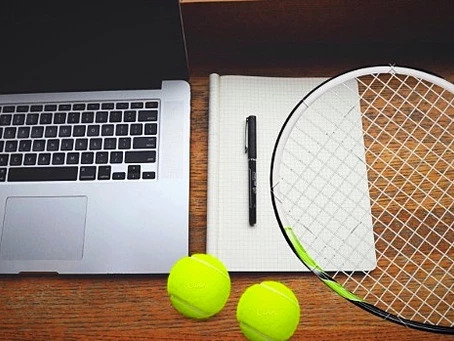 laptop,tennis balls, raket,pen and copy