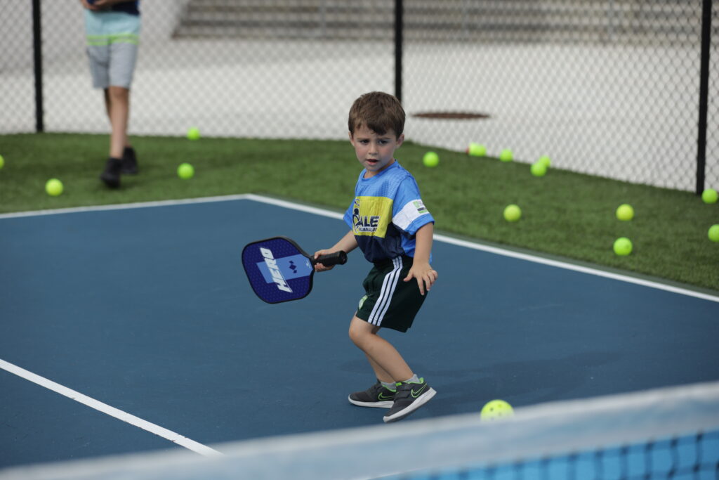 Child playing pickleball in Miami