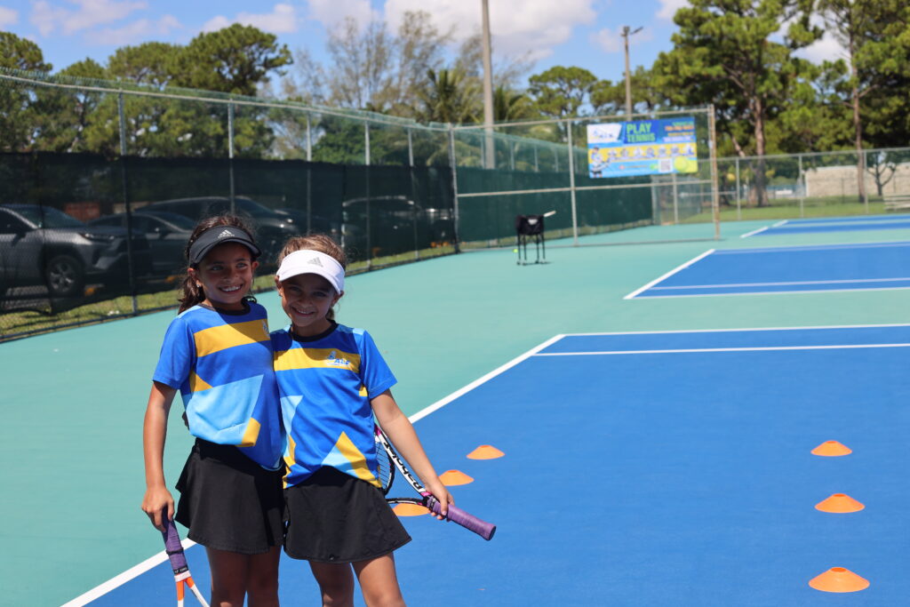 Two smiling girls at free tennis trial class in miami